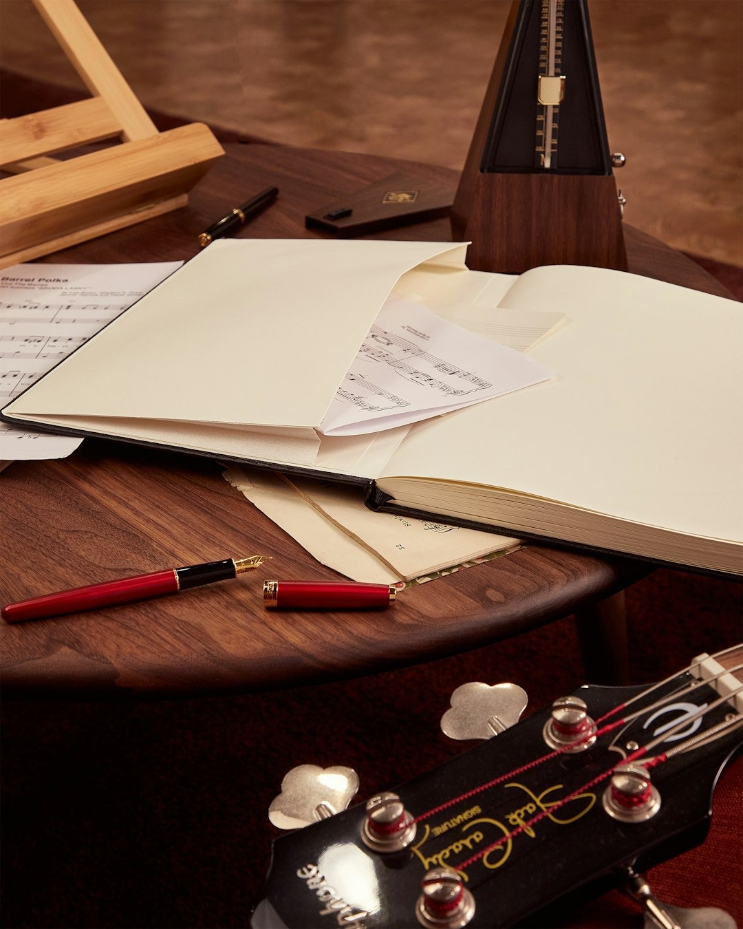 Musical instruments and sheet music arranged on a wooden desk.